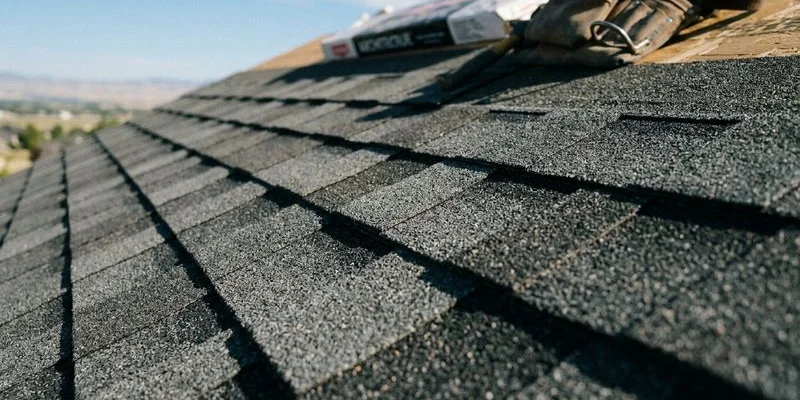 Detailed view of architectural asphalt shingles installed on a residential roof showing dimensional texture and color variation